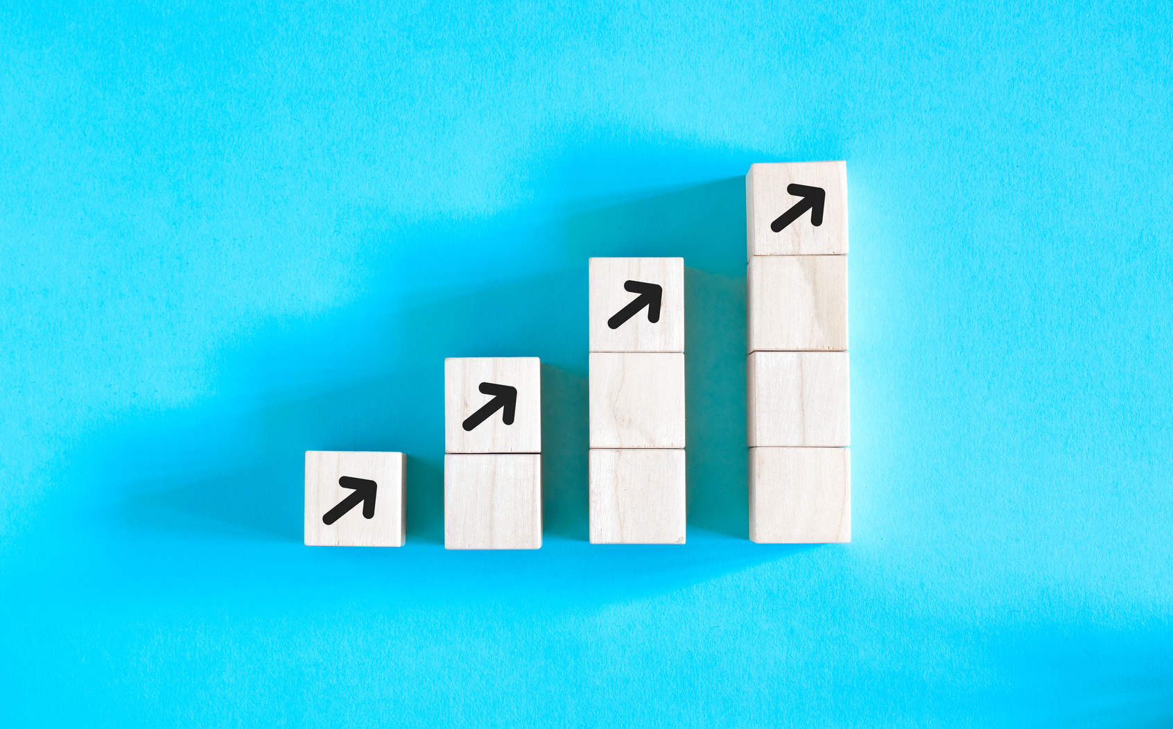 Business concept growth success process, Close up Woman hand arranging wood block stacking as step stair on paper blue background, copy space.